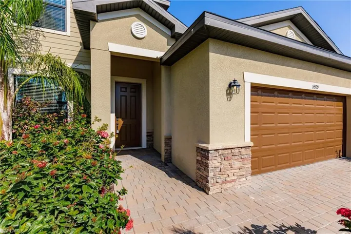 View of exterior entry with a garage