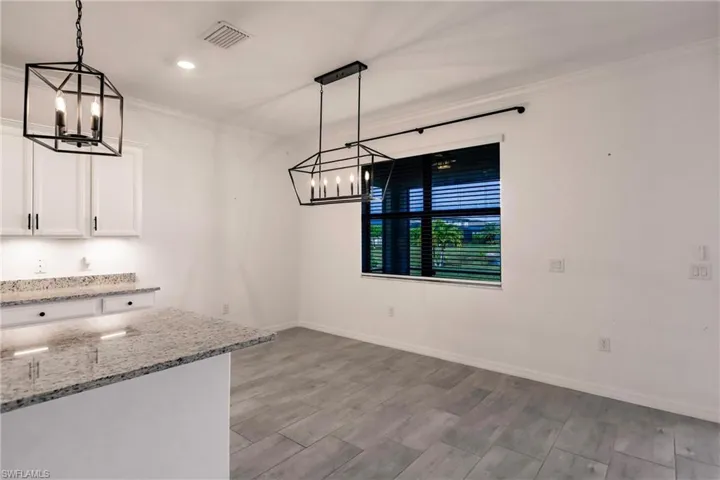 Unfurnished dining area featuring light hardwood / wood-style flooring and ornamental molding