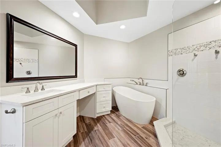 Full bath featuring a walk in shower, vanity, and recessed lighting