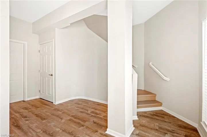 Staircase with baseboards and vinyl finished floors