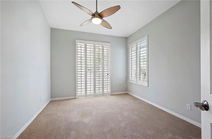 Spare room featuring ceiling fan, baseboards, and carpet flooring