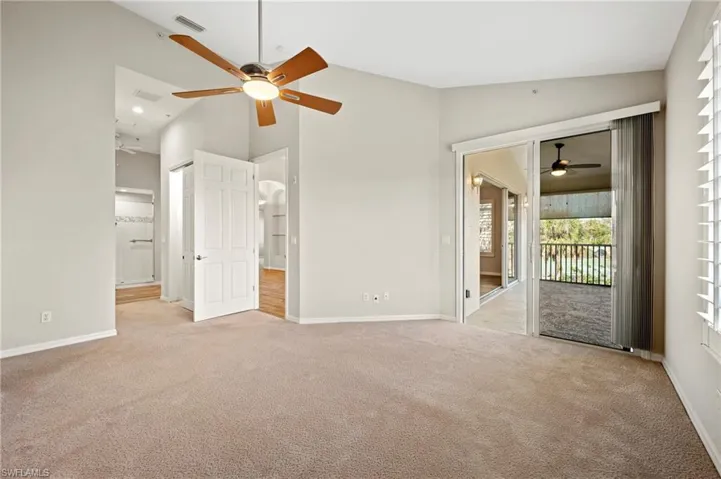 Unfurnished bedroom with baseboards, access to outside, and light colored carpet