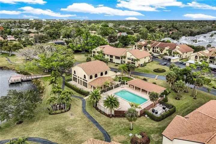 Aerial view of clubhouse, main pool area, and fishing dock.