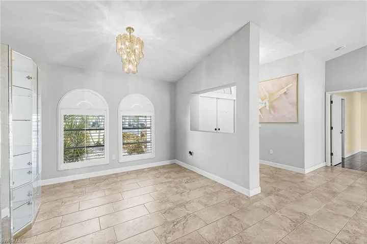 Dining room featuring a chandelier and lofted ceiling
