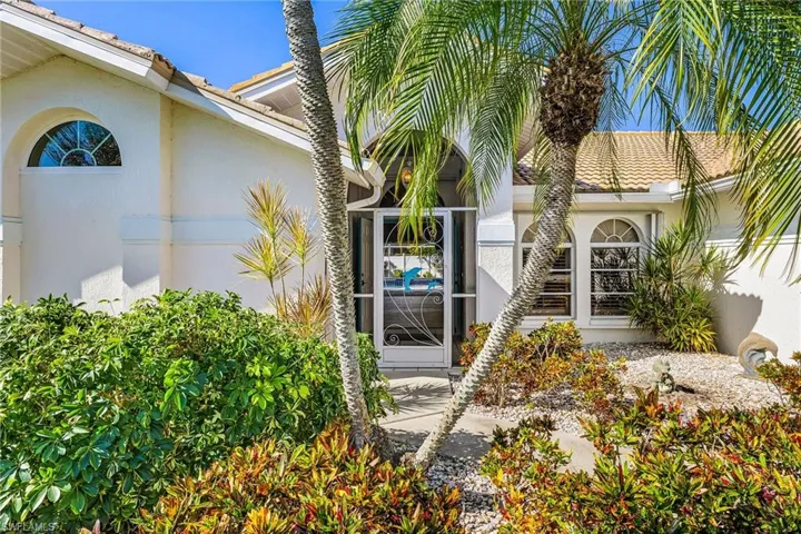 View of exterior entry with stucco siding, screened front entry to catch the river breezes