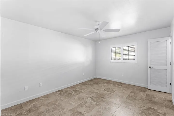 Bedroom #2 with baseboards and ceiling fan and walk in closet