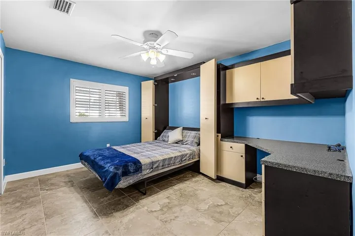 Bedroom #3 with built in desk and murphy bed and ceiling fan. Set for home office area and bedroom