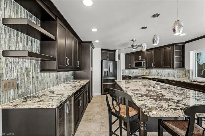 Kitchen with open shelves, pantry, wine cooler, soft close drawers and cabinets with pull out drawers dark