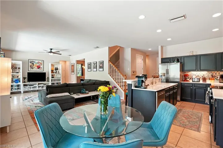 ChatGPT said:Open-concept living area seamlessly connects the kitchen, dining, and family room, creating the perfect flow for entertaining. Modern dark cabinetry, stainless steel appliances, and a stylish backsplash complement the bright, inviting space. Tile floors, recessed lighting, and a neutral palette enhance the airy feel, while sliding doors lead to the screened pool and patio. Ideal for Florida living, this versatile layout offers comfort, functionality, and easy access to Gulf Coast attractions.