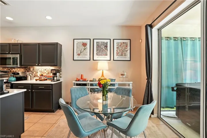 ChatGPT said:Open-concept living area seamlessly connects the kitchen, dining, and family room, creating the perfect flow for entertaining. Modern dark cabinetry, stainless steel appliances, and a stylish backsplash complement the bright, inviting space. Tile floors, recessed lighting, and a neutral palette enhance the airy feel, while sliding doors lead to the screened pool and patio. Ideal for Florida living, this versatile layout offers comfort, functionality, and easy access to Gulf Coast attractions.