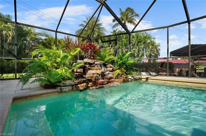 Outdoor pool with a lanai and a sunroom