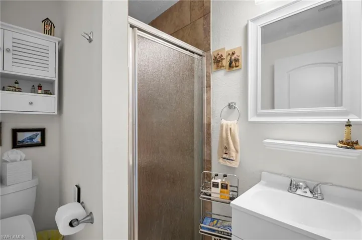 Full bathroom featuring a shower stall and vanity