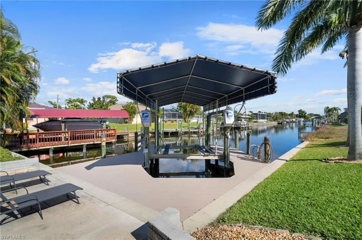 Dock with boat lift and a water view