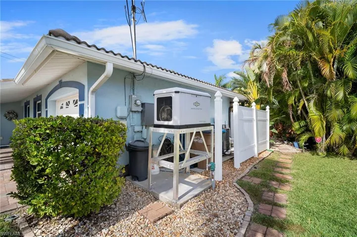 View of side of property featuring stucco siding and a yard
