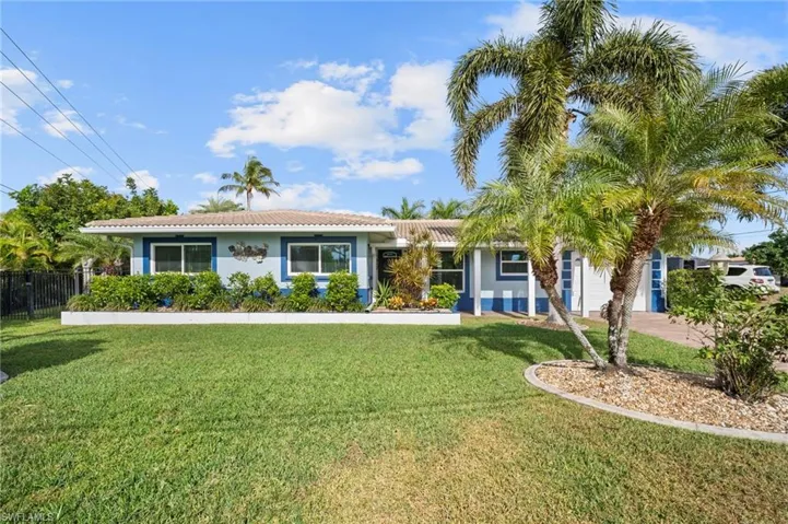 Ranch-style house with a tile roof and stucco siding