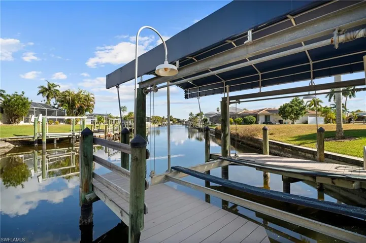 Dock with boat lift and a water view