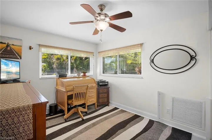Office with baseboards and a ceiling fan