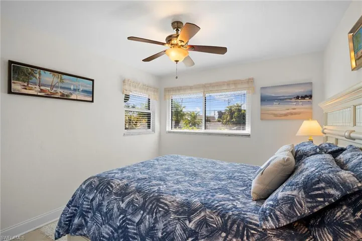 Bedroom with baseboards and a ceiling fan