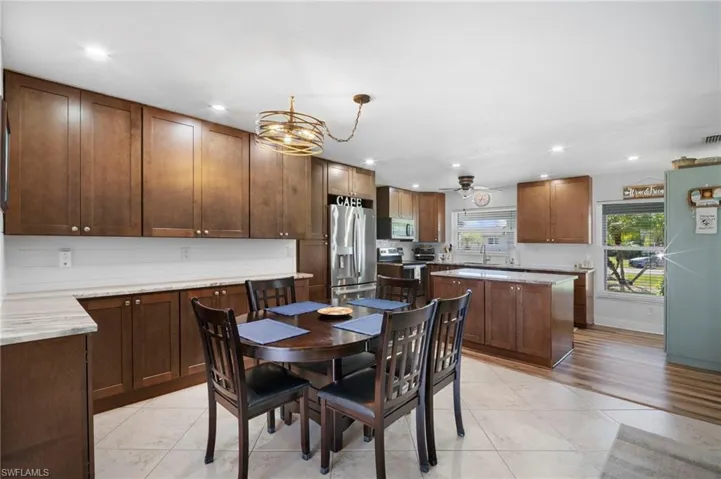 Dining area featuring recessed lighting and light tile patterned flooring