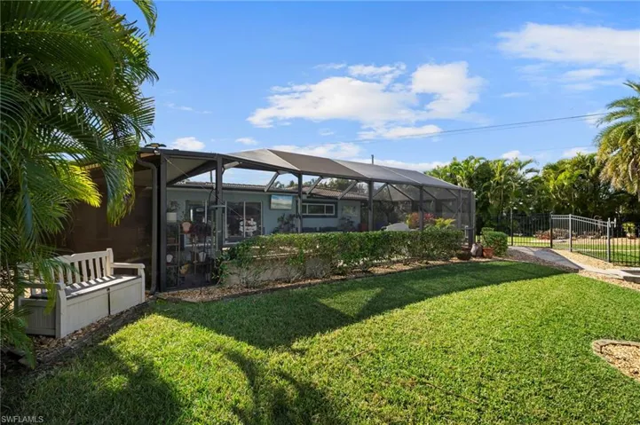 View of yard with glass enclosure and a sunroom