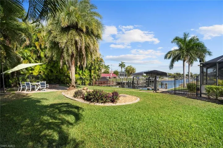 View of yard with a lanai, a patio, a community pool, and a sunroom