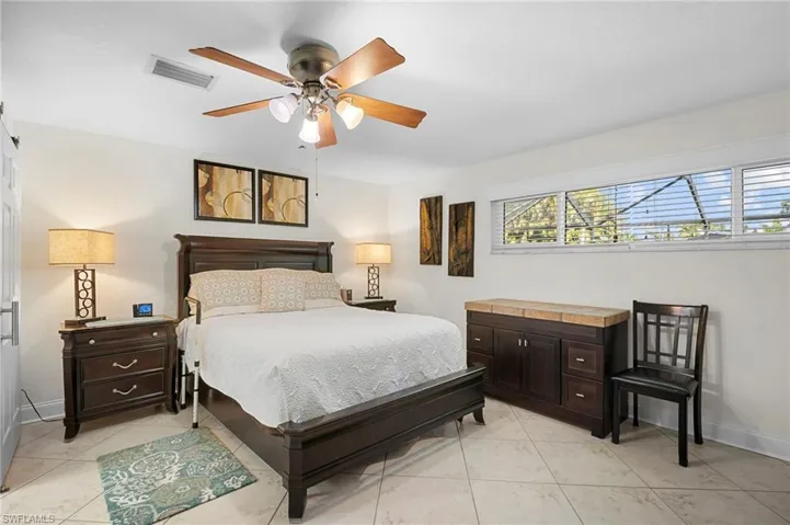 Bedroom featuring ceiling fan and light tile patterned flooring