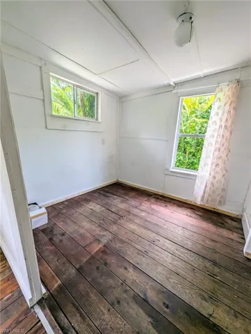 Unfurnished room featuring dark hardwood / wood-style flooring