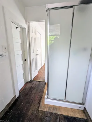 Hallway with hardwood / wood-style flooring