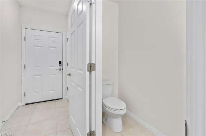 Bathroom featuring light tile patterned floors and baseboards