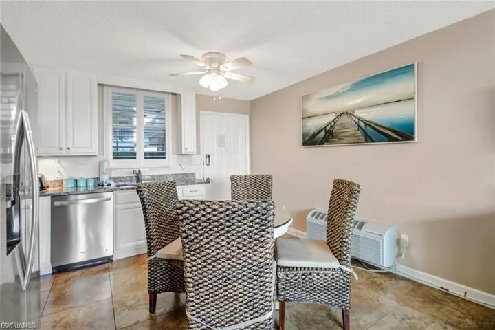 Dining area with ceiling fan, and an AC wall unit