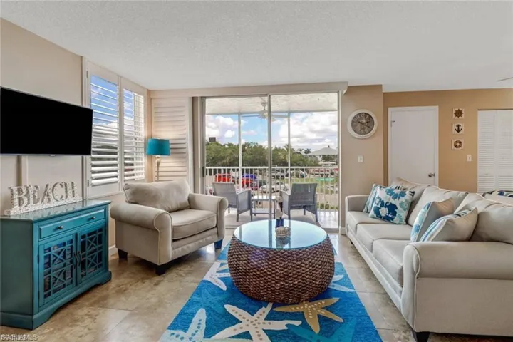 Living area with screened lanai/balcony view.