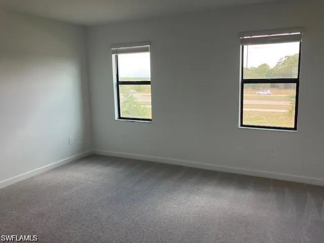 Unfurnished room with carpet