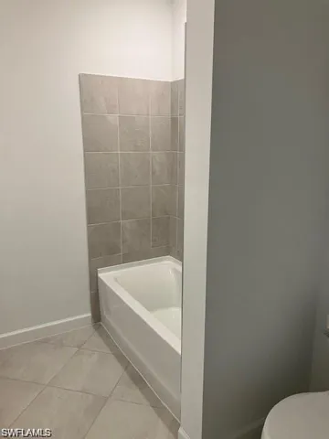 Bathroom with toilet and tile patterned flooring