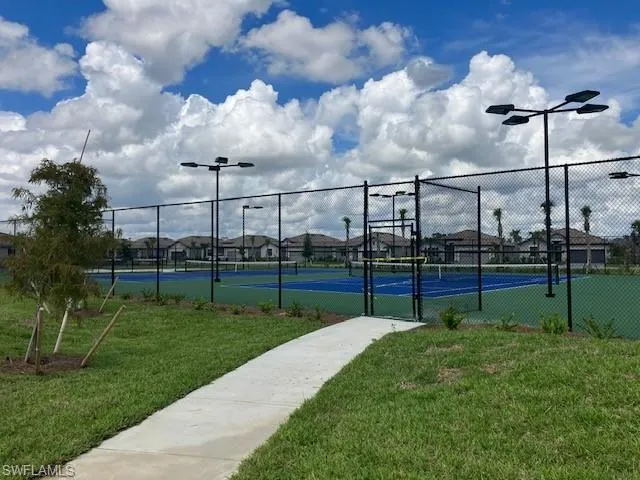 View of sport court featuring a lawn
