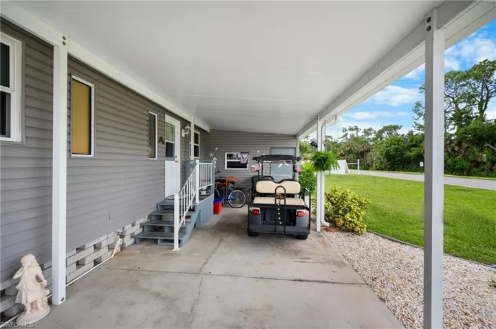 View of vehicle parking with an attached carport