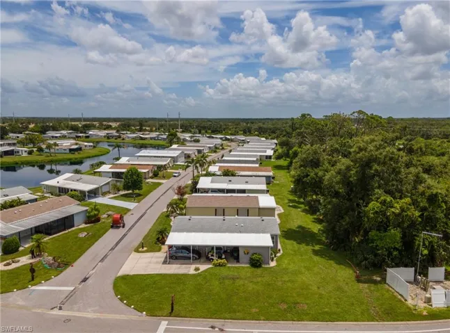 Aerial view of residential area featuring a nearby body of water