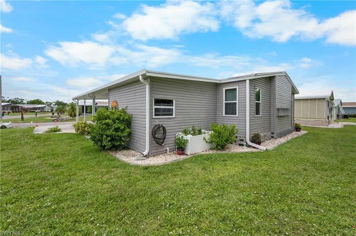 View of side of property featuring a lawn