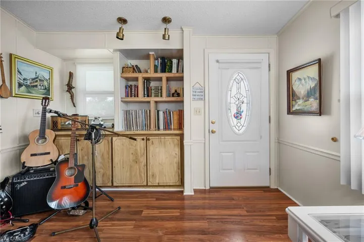 Entrance foyer featuring a textured ceiling and dark wood finished floors