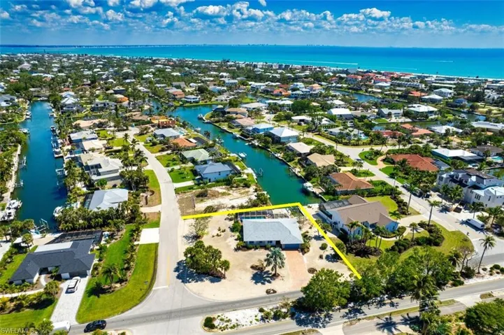 Aerial view of residential area featuring a large body of water