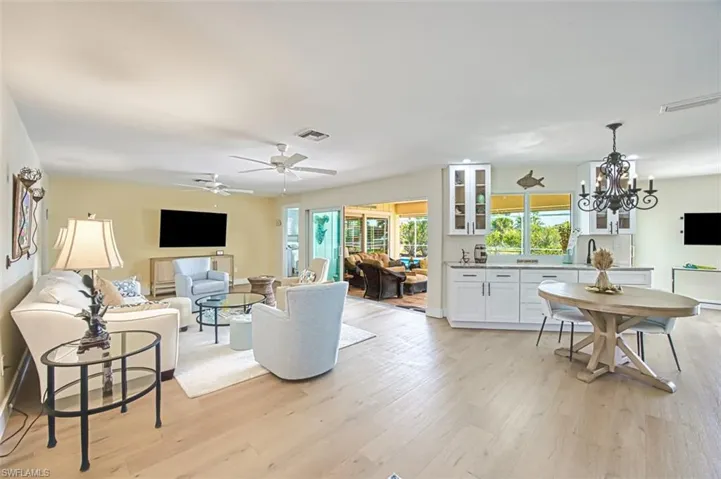 Living room featuring light wood-style flooring and a chandelier