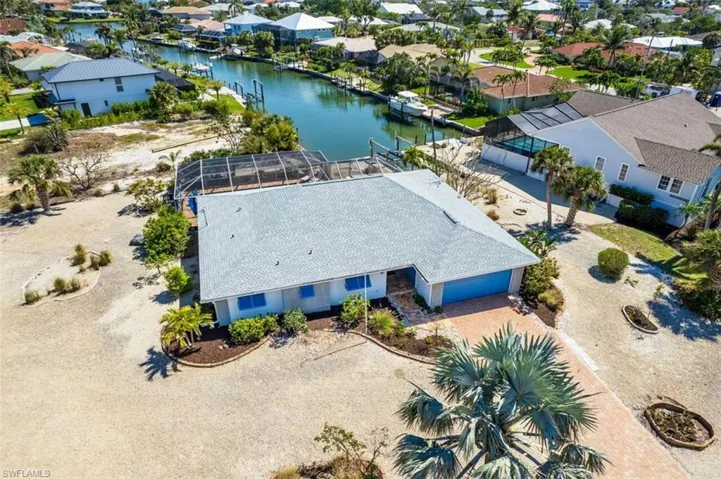 Aerial perspective of suburban area with a nearby body of water