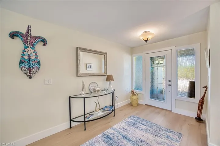 Entrance foyer with light wood-style floors