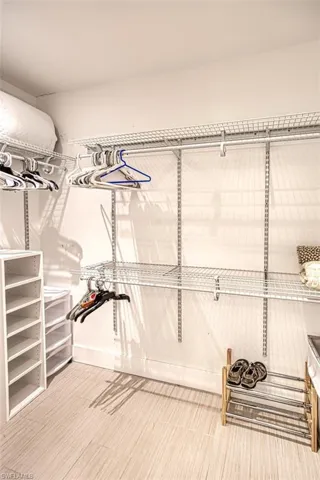 Walk in closet featuring light wood-style floors