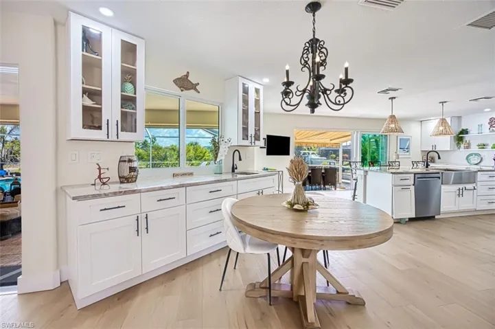 Dining room with a chandelier, light wood-style flooring, and recessed lighting