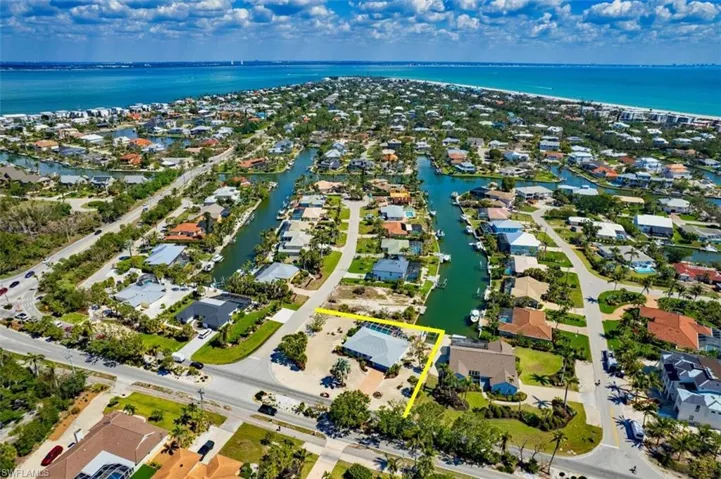 Aerial perspective of suburban area featuring a large body of water