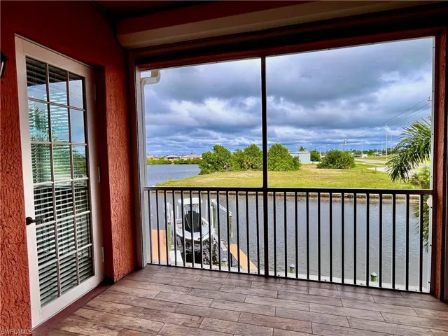 Second floor screened in balcony featuring a water view