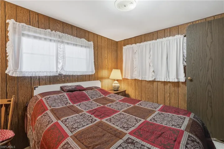 Bedroom featuring wood walls