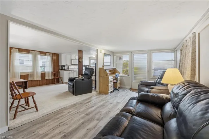 Living area featuring light wood-style floors and baseboards