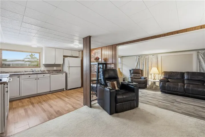 Living area featuring light wood finished floors and light colored carpet