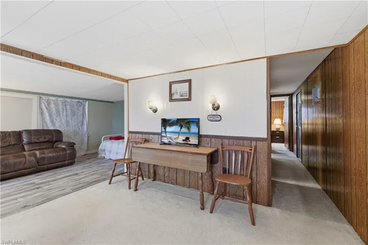 Office area with wooden walls, carpet floors, and wainscoting
